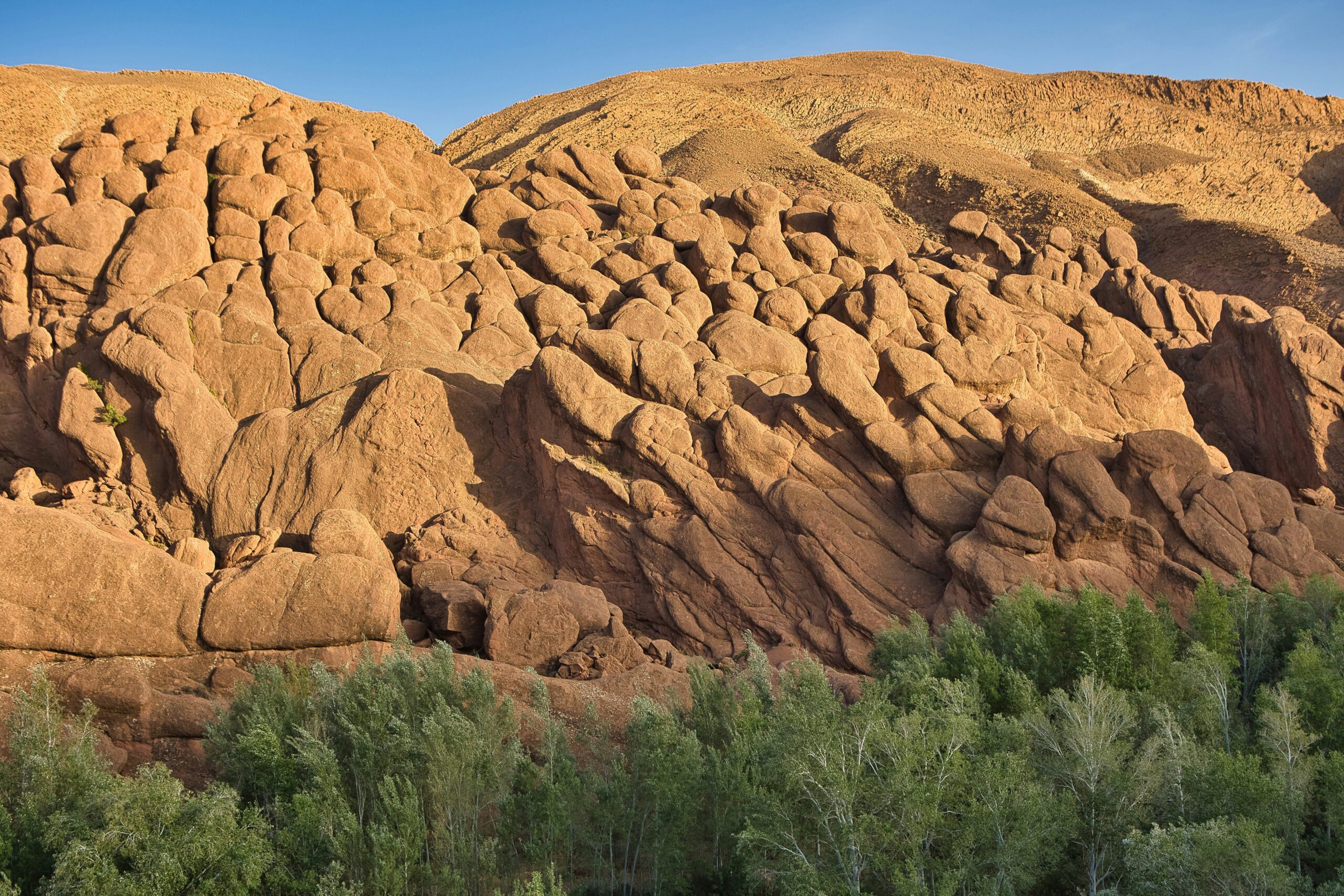 The Monkey Fingers rock formations in Dades Gorge, Morocco, are a stunning natural wonder. These unique, eroded sandstone formations resemble giant fingers rising from the valley floor, creating a surreal and picturesque landscape.
